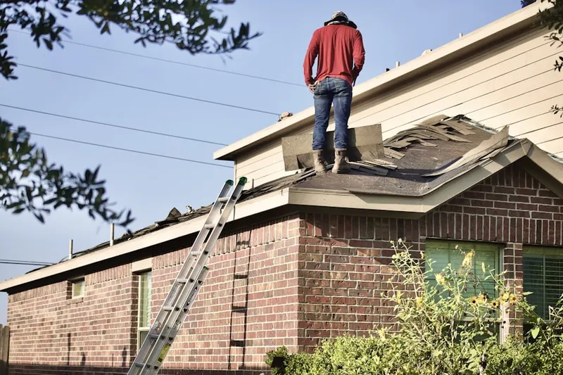 Professional roofer working on a residential roof in Pilot Point
